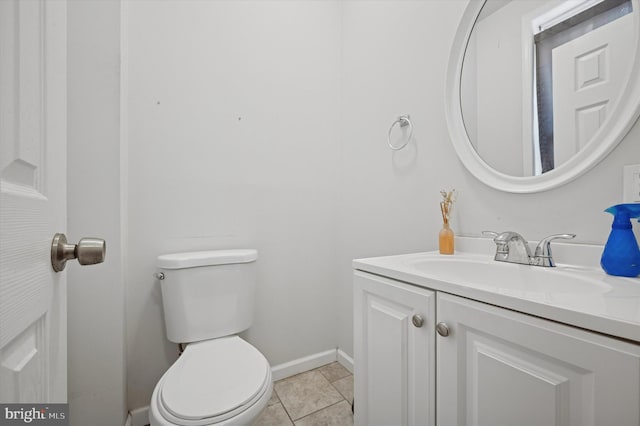bathroom featuring toilet, baseboards, and vanity