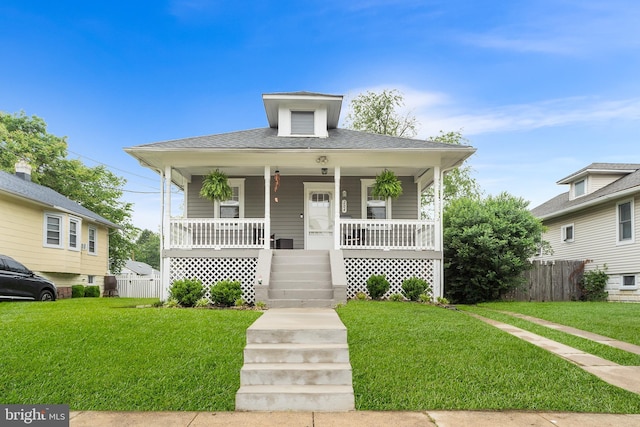 bungalow featuring a porch and roof with shingles