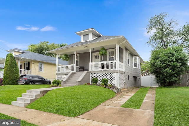 bungalow-style home with covered porch, stairs, and a gate