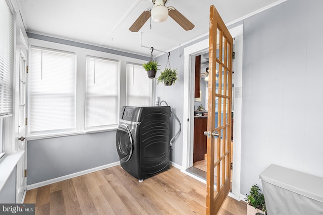 sitting room featuring washer / clothes dryer, a ceiling fan, and wood finished floors