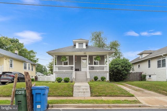 bungalow-style house with a porch and a shingled roof