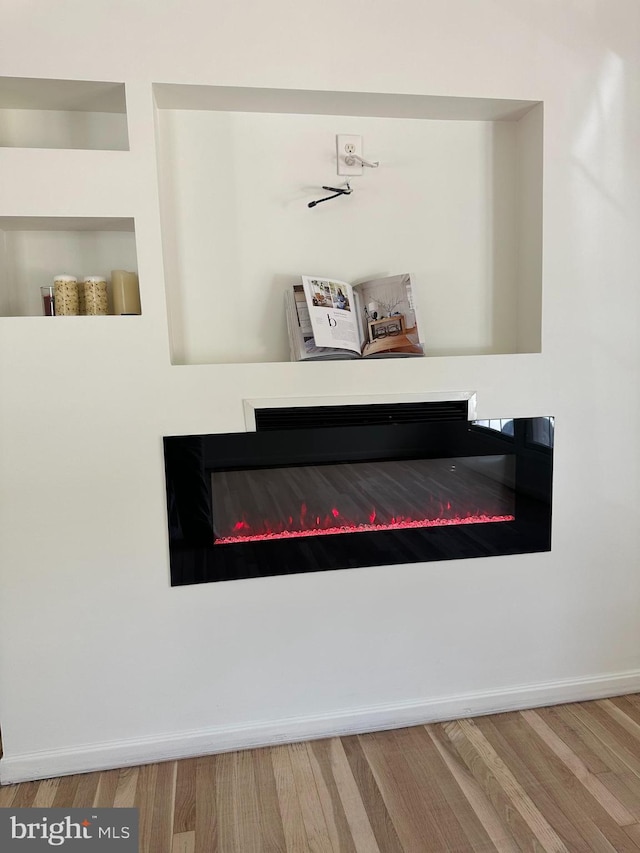 15213 Michigan Rd, Woodbridge, VA 22191 - detailed view of a glass covered fireplace, wood finished floors, and baseboards