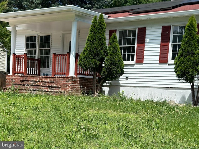 15213 Michigan Rd, Woodbridge, VA 22191 - view of front facade with a porch and roof mounted solar panels