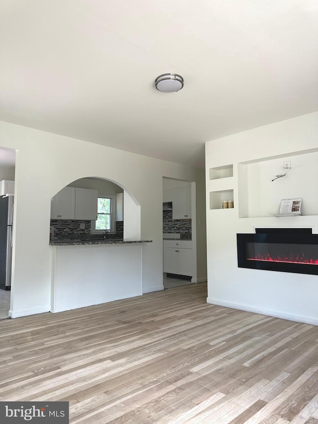 15213 Michigan Rd, Woodbridge, VA 22191 - unfurnished living room with a glass covered fireplace and light wood finished floors