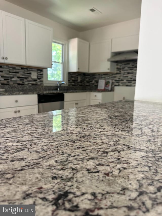 15213 Michigan Rd, Woodbridge, VA 22191 - kitchen with exhaust hood, dark stone countertops, backsplash, and white cabinetry