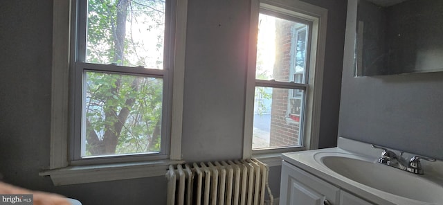 bathroom with radiator and vanity