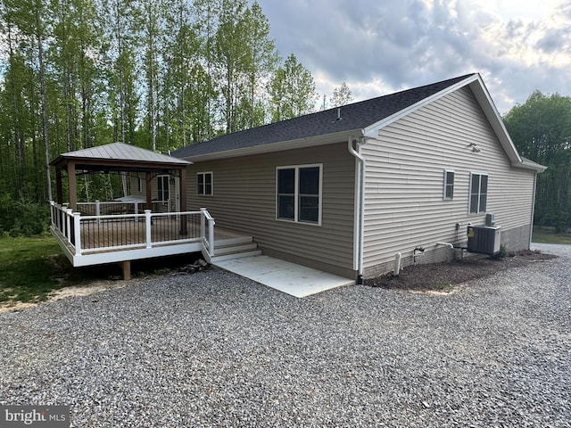 rear view of property featuring a gazebo, central AC, crawl space, a wooden deck, and a shingled roof