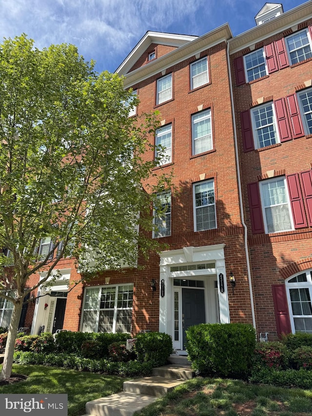 view of property featuring brick siding
