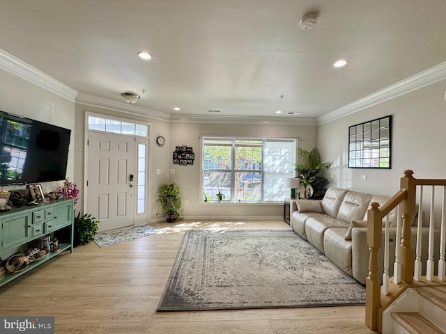 living area with healthy amount of natural light, crown molding, light wood-type flooring, recessed lighting, and baseboards