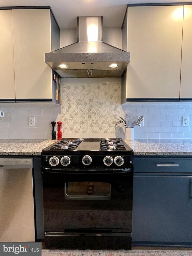 kitchen with black range with gas stovetop, wall chimney range hood, stainless steel dishwasher, decorative backsplash, and light stone counters