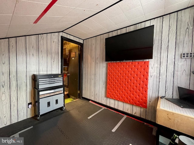 additional living space with wood walls and lofted ceiling