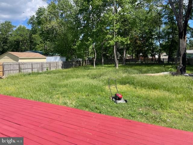 view of yard with a wooden deck and fence