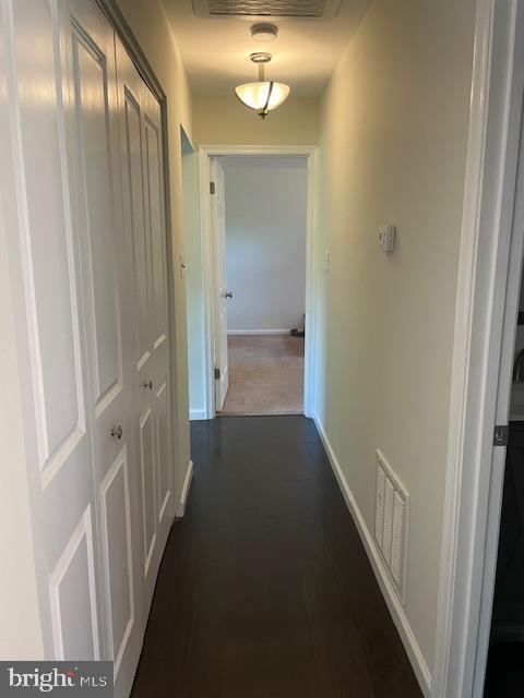 hall featuring baseboards