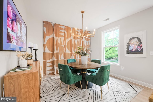 502 King Farm Blvd Unit 202, Rockville, MD 20850 - dining room with an inviting chandelier, visible vents, wood finished floors, and baseboards