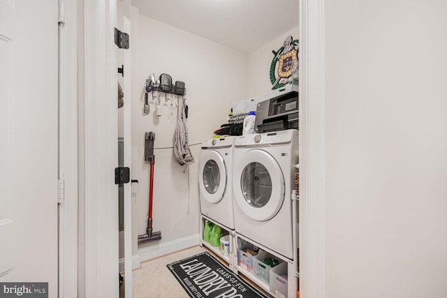 502 King Farm Blvd Unit 202, Rockville, MD 20850 - washroom featuring washing machine and dryer, laundry area, baseboards, and tile patterned floors