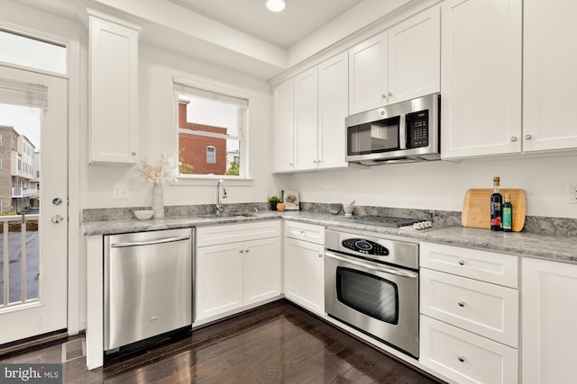 906 3rd St SE, Washington, DC 20003 - kitchen featuring stainless steel appliances, a sink, dark wood finished floors, white cabinets, and recessed lighting