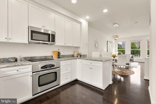 906 3rd St SE, Washington, DC 20003 - kitchen with appliances with stainless steel finishes, a peninsula, white cabinetry, recessed lighting, and dark wood finished floors