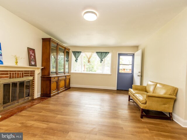 6215 Seminole Pl, College Park, MD 20740 - living area with light wood finished floors, plenty of natural light, baseboards, and a fireplace