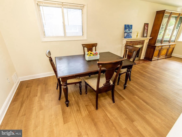 6215 Seminole Pl, College Park, MD 20740 - dining space featuring light wood-type flooring, baseboards, and a fireplace