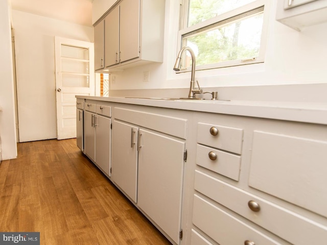 6215 Seminole Pl, College Park, MD 20740 - kitchen with a sink, light countertops, and wood finished floors