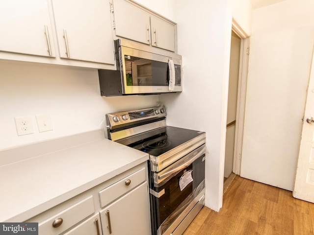 6215 Seminole Pl, College Park, MD 20740 - kitchen featuring stainless steel appliances, light countertops, and light wood-style floors
