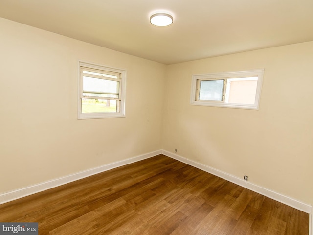 6215 Seminole Pl, College Park, MD 20740 - unfurnished room with baseboards, healthy amount of natural light, and dark wood-style flooring