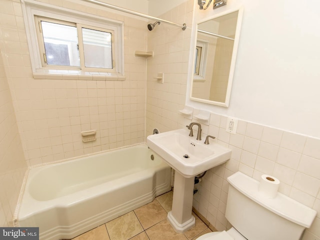6215 Seminole Pl, College Park, MD 20740 - bathroom featuring toilet, shower / bathtub combination, tile patterned floors, and tile walls
