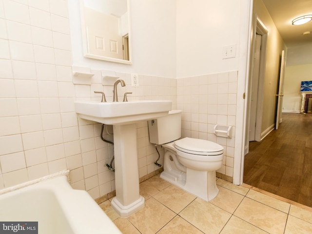 6215 Seminole Pl, College Park, MD 20740 - bathroom featuring tile walls, tile patterned floors, toilet, and wainscoting