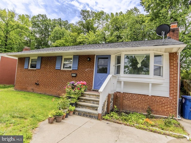 6215 Seminole Pl, College Park, MD 20740 - view of front of house featuring a chimney, brick siding, a front lawn, and roof with shingles