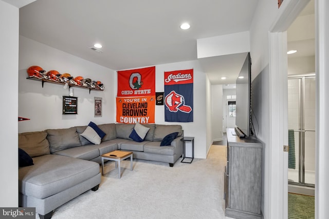 living area featuring light colored carpet and recessed lighting
