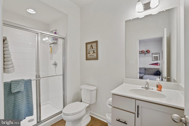 bathroom with ensuite bath, a shower stall, toilet, vanity, and wood finished floors
