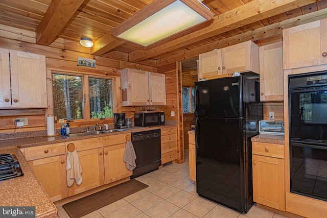 kitchen with light brown cabinets, light tile patterned floors, beamed ceiling, a sink, and black appliances