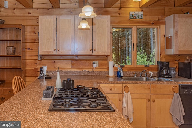 kitchen with beamed ceiling, wooden walls, stovetop with downdraft, and a sink