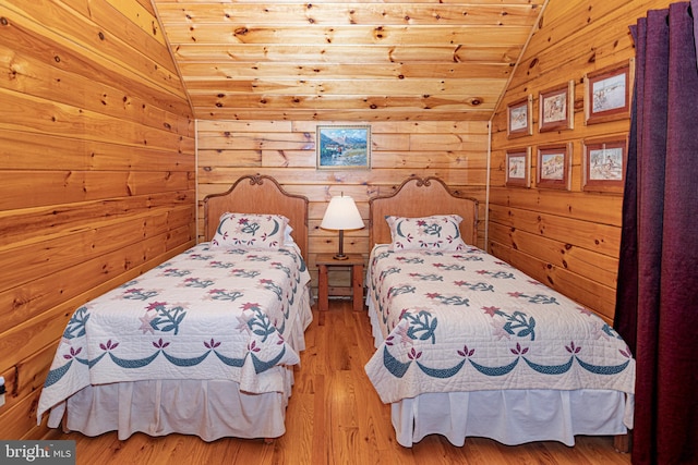 bedroom featuring wooden ceiling, lofted ceiling, wood finished floors, and wood walls