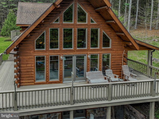 exterior space featuring a wooden deck and log exterior