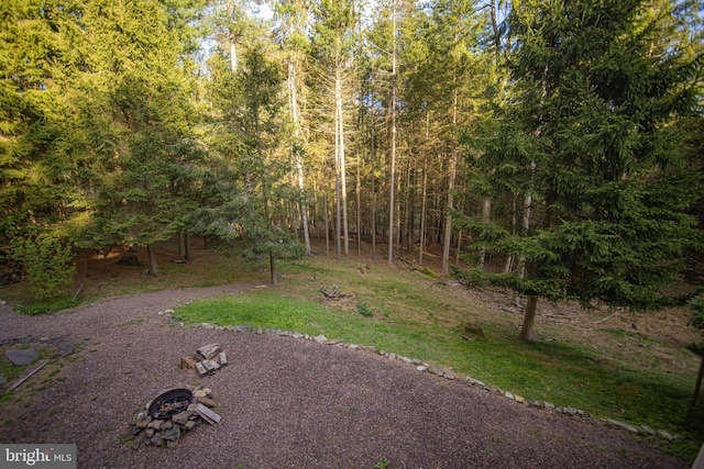view of yard featuring a forest view