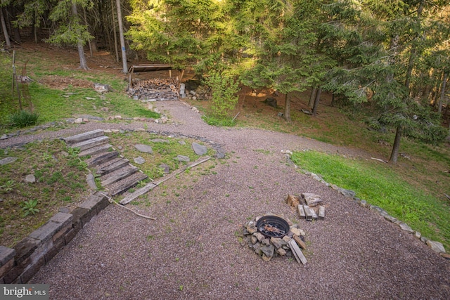 view of yard with a fire pit