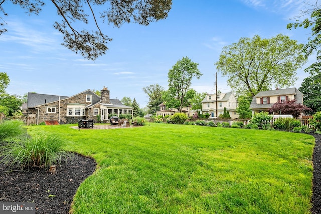 view of yard featuring a patio and a residential view