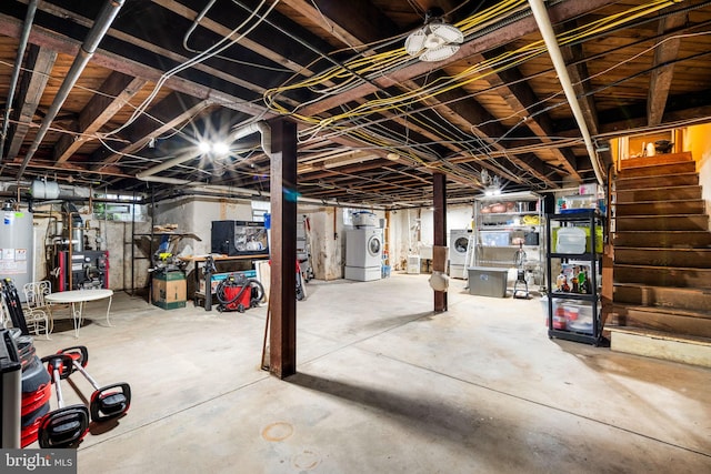 unfinished below grade area featuring washer / clothes dryer, stairs, and water heater