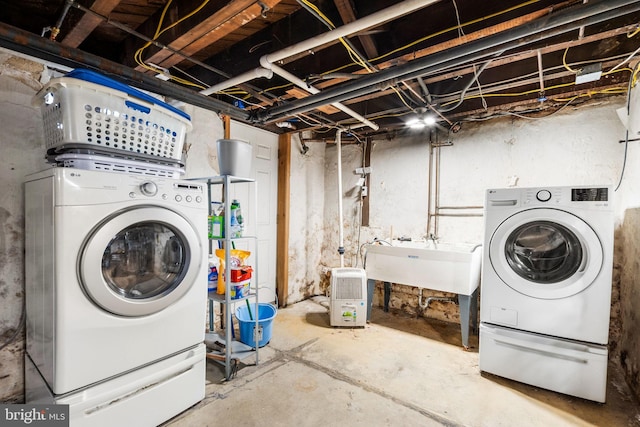 clothes washing area with washing machine and clothes dryer