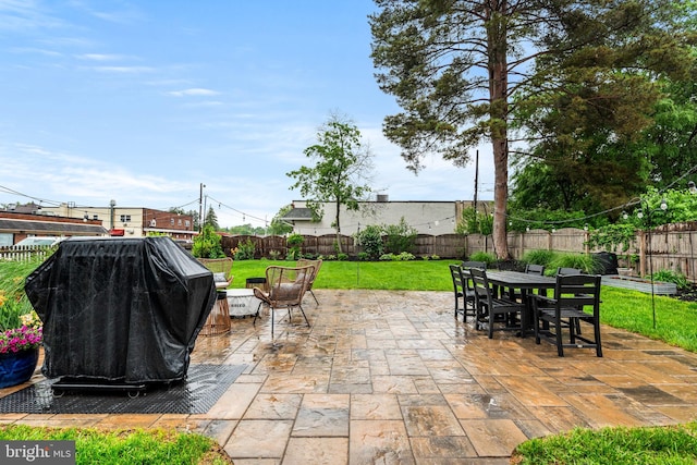 view of patio / terrace featuring outdoor dining area and a grill
