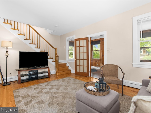 206 Shiley St, Annapolis, MD 21401 - living area featuring baseboard heating, stairway, and wood finished floors