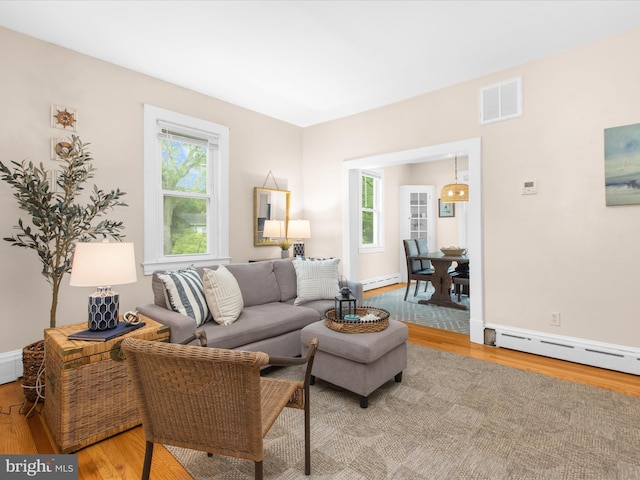 206 Shiley St, Annapolis, MD 21401 - living room featuring a baseboard radiator, light wood finished floors, and healthy amount of natural light