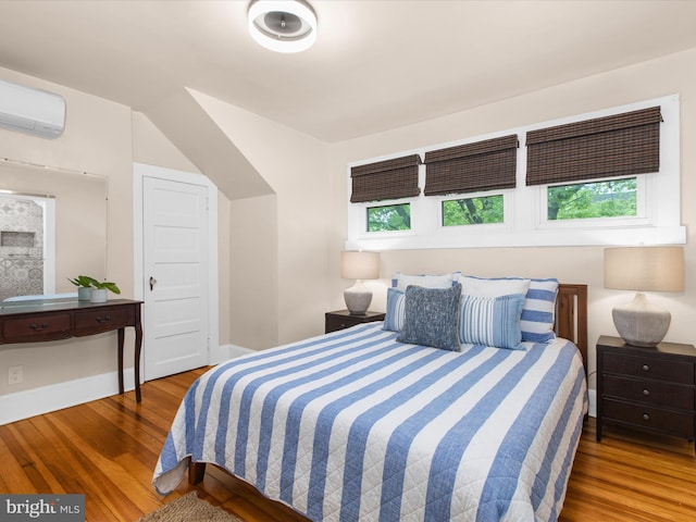 206 Shiley St, Annapolis, MD 21401 - bedroom with wood finished floors, a wall mounted air conditioner, and baseboards