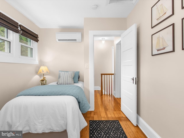 206 Shiley St, Annapolis, MD 21401 - bedroom featuring a wall mounted AC, light wood-style floors, baseboards, and attic access