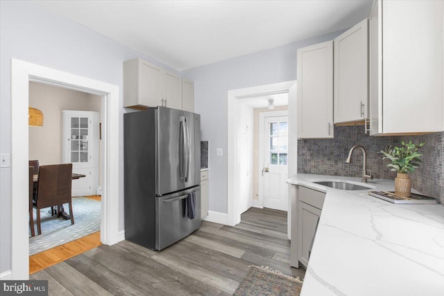 206 Shiley St, Annapolis, MD 21401 - kitchen featuring freestanding refrigerator, a sink, wood finished floors, and tasteful backsplash