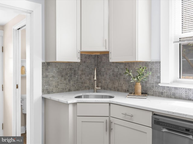 206 Shiley St, Annapolis, MD 21401 - kitchen featuring dishwasher, a sink, decorative backsplash, and white cabinetry
