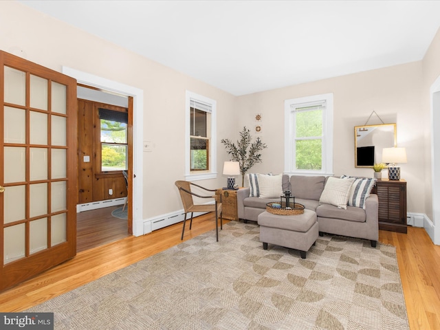 206 Shiley St, Annapolis, MD 21401 - living room featuring baseboard heating, wood finished floors, and baseboards