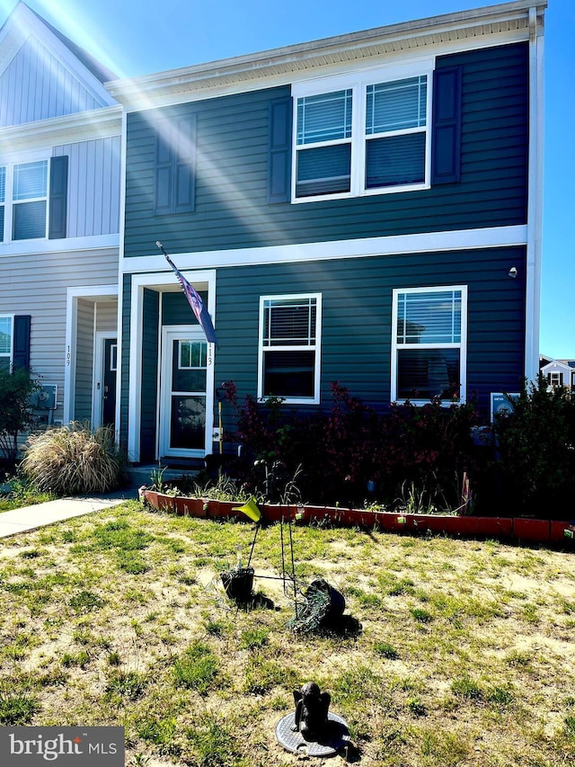 113 Dyer Dr, Camden Wyoming, DE 19934 - view of front of house with board and batten siding and a front yard
