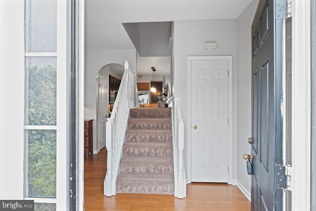 5971 Schooner Cir, King George, VA 22485 - entrance foyer with wood finished floors, arched walkways, and stairway